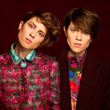 Tegan and Sara on a maroon background with colourful patterned shirts
