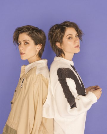 Medium shot of Sara and Tegan in front of a purple background