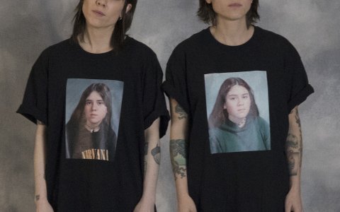 Tegan and Sara, wearing t-shirts with pictures of their high school selves.